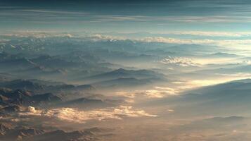Aerial View of Mountain Range at Sunrise with Golden Clouds photo