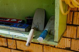 A shelf with tools and a hose on it photo