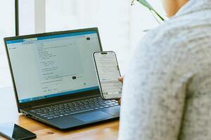 A woman using a laptop to access a website photo