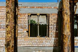 A man standing in front of a building with a ladder photo