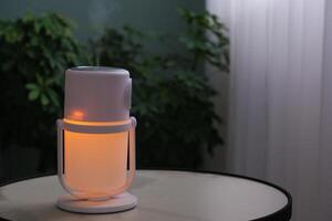 An illuminated humidifier on the table in the room photo