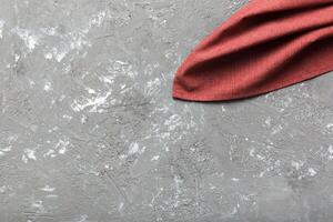 top view red empty kitchen napkin isolated on table. Folded cloth for mockup photo