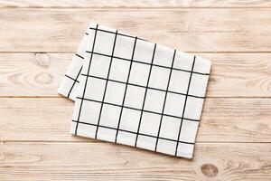 top view with white empty kitchen napkin isolated on table . Folded cloth for mockup photo