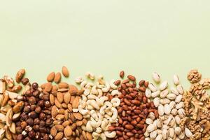 different nuts frame background. flat lay with vopy space. Walnut, almonds, hazelnuts photo
