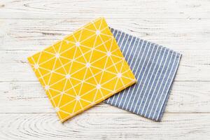 top view yellow empty kitchen napkin isolated on table background. Folded cloth for mockup , Minimal style photo