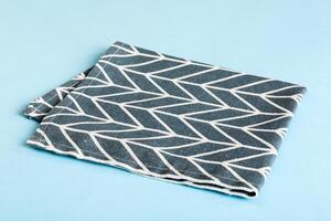 top view with blue kitchen napkin isolated on table background. Folded cloth mockup with copy space photo