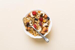Cooking a wholesome breakfast. Granola with Various dried fruits and nuts in a bowl. The concept of a healthy dessert. top view photo