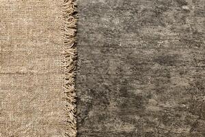 Old burlap fabric napkin, sackcloth table background. top view photo