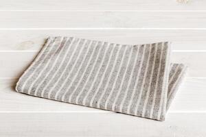 top view gray kitchen napkin isolated on table background. Folded cloth for mockup with copy space photo