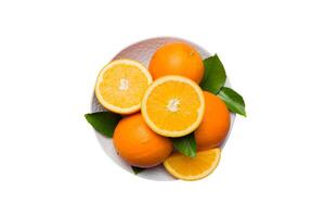 Flat lay Fresh orange fruit with sliced in plate isolated on white background. Top view photo