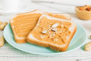 Peanut butter sandwiches toasts light table background. Breakfast. American cuisine photo