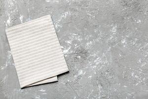 top view with gray kitchen napkin isolated on table background. Folded cloth for mockup copy space photo