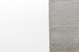 top view gray kitchen napkin isolated on table background. Folded cloth for mockup with copy space, photo