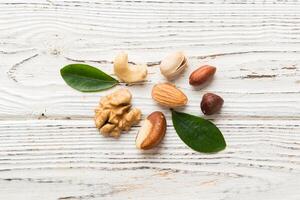 Composition of nuts , flat lay mix hazelnuts, cashews, almonds on table background. healthy eating concepts photo