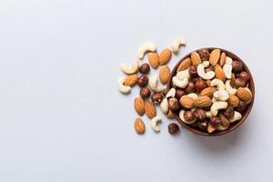 Assortment of nuts in wooden bowl on table. Cashew, hazelnuts, walnuts, almonds. Mix of nuts Top view with copy space photo