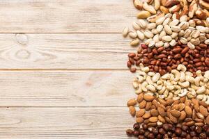 different nuts frame background. top view, flat lay with vopy space. Walnut, pistachios, hazelnuts and cashews photo