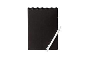Top view closed spiral blank dark paper cover notebook with pencil isolated on white background photo