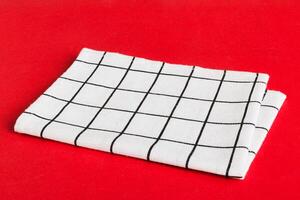 top view white empty kitchen napkin isolated on table background. Folded cloth mockup with copy space, photo