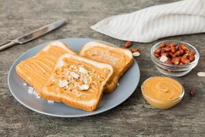 Peanut butter sandwiches or toasts on light table background.Breakfast. Vegetarian food. American cuisine top view photo