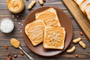 Peanut butter sandwiches toasts on light table background. Breakfast. Vegetarian food. American cuisine top view photo