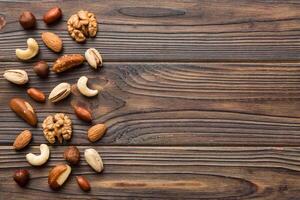 Composition nuts , flat lay - mix hazelnuts, cashews, almonds on table background. healthy eating concepts and food photo