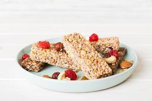 Various granola bars table background. Cereal granola bars. Superfood breakfast bars with oats, nuts and berries. photo
