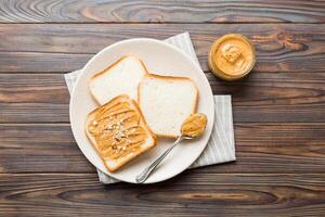 Peanut butter sandwiches toasts light table background. photo