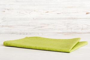 top view with green kitchen napkin isolated on table background. Folded cloth for mockup copy space photo