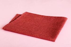top view red empty kitchen napkin isolated table background. Folded cloth for mockup with copy space, photo