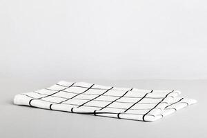 top view with white empty kitchen napkin isolated on table background. Folded cloth for mockup with copy space. photo