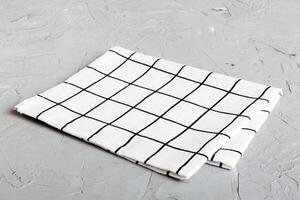 top view white empty kitchen napkin isolated on table background. Folded cloth mockup with copy space photo