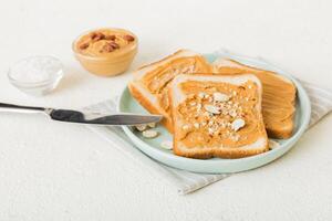 Peanut butter sandwiches or toasts on light table background.Breakfast. Vegetarian food. top view photo