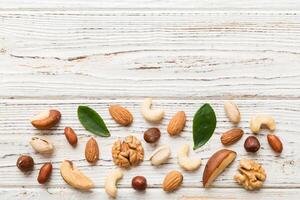 Composition of nuts , flat lay mix hazelnuts, cashews, almonds table background. healthy eating concepts and food background photo