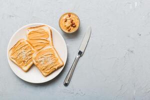 Peanut butter sandwiches toasts light table background. American cuisine photo