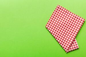 top view with red empty kitchen napkin isolated on table . Folded cloth for mockup photo