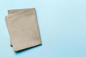 top view with gray kitchen napkin isolated on table background. Folded cloth for mockup with copy space, photo