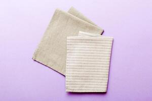 top view gray kitchen napkin isolated on table background. Folded cloth for mockup with copy space, Minimal style photo