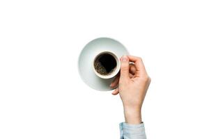 Minimalistic style woman hand holding cup of coffee on Colored background. Flat lay, top view cappuccino cup. Empty place for text, copy space. Coffee addiction. Top view, flat lay photo