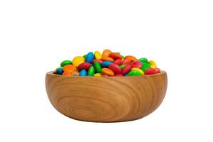 Multicolored candies in a bowl on colored background. birthday and holiday concept. Top view with copy space photo