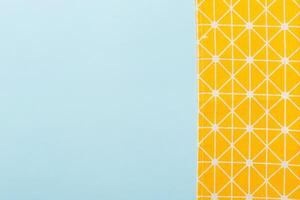 top view with yellow empty kitchen napkin isolated on table. Folded cloth for mockup with copy space, photo