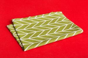 top view green kitchen napkin isolated table background. Folded cloth for mockup with copy space, Flat lay. Minimal style photo
