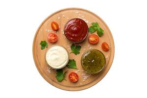 Many different sauces and herbs isolated on white background, flat lay top view. sauces plate, healthy concept photo
