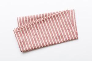 top view red kitchen napkin isolated on table background. Folded cloth for mockup with copy space photo