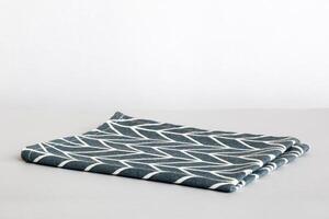 top view with blue kitchen napkin isolated on table background. Folded cloth for mockup with copy space photo