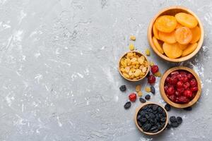 Bowl with different dried fruits table background, Healthy lifestyle with copy space photo
