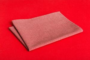 top view red empty kitchen napkin isolated on table background. Folded cloth for mockup with copy space. photo