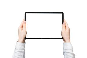 Close up image woman hands holding digital tablet with blank copy space screen for your text message or promotional content om table with cup of coffee. hands of woman holding blank tablet device photo