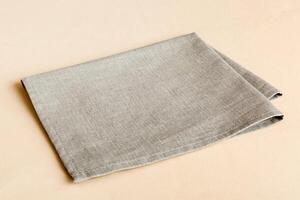 top view with gray kitchen napkin isolated on table background. Folded cloth for mockup photo