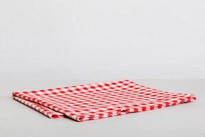 top view red empty kitchen napkin isolated on table background. Folded cloth for mockup photo