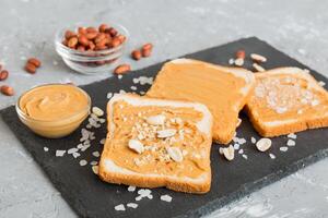 Peanut butter sandwiches toasts on light table background.Breakfast. American cuisine top view photo